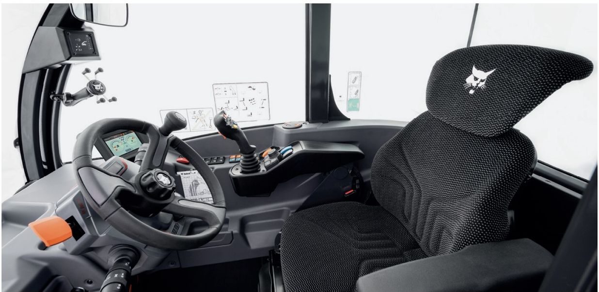 Cab interior with steering wheel, digital display and smart joystick on the armrest