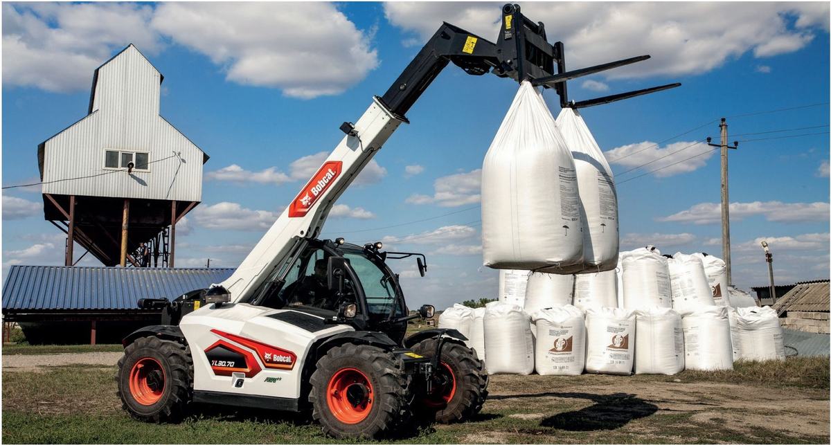 Bobcat telehandler lifting fertiliser bulk bags on a farm
